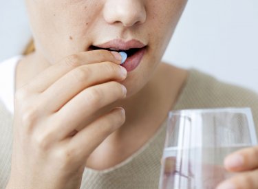 Woman taking medication Woman taking medication